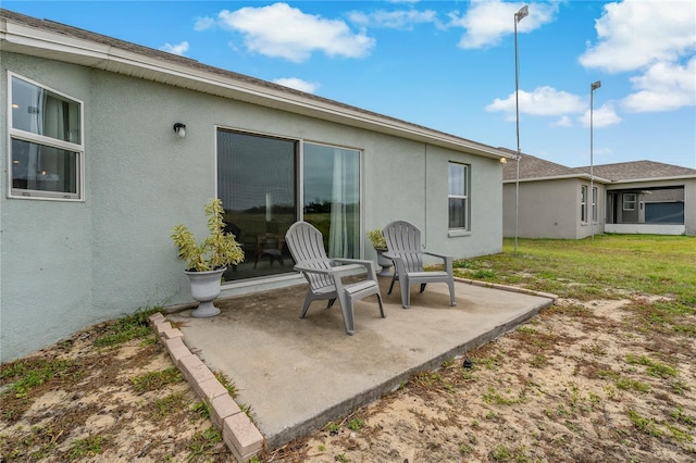 back of property with a patio area and a lawn