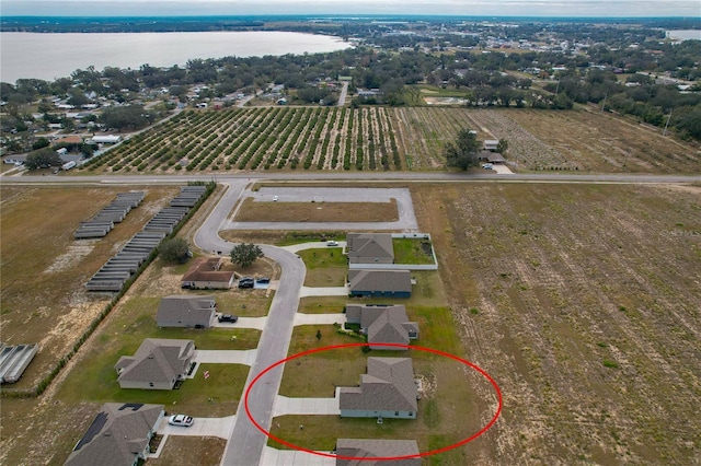 birds eye view of property featuring a water view and a rural view