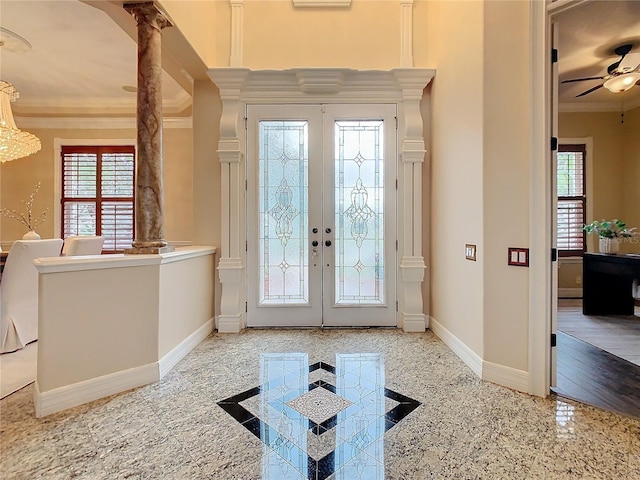 foyer featuring ceiling fan, ornamental molding, a healthy amount of sunlight, and french doors