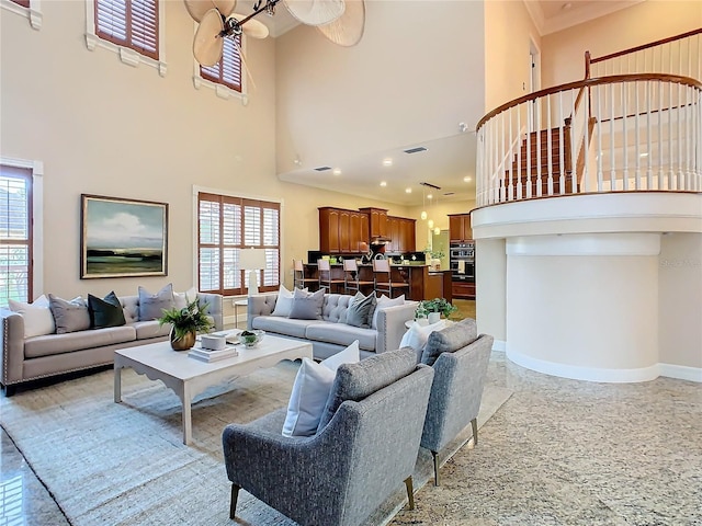 living room featuring a towering ceiling and plenty of natural light