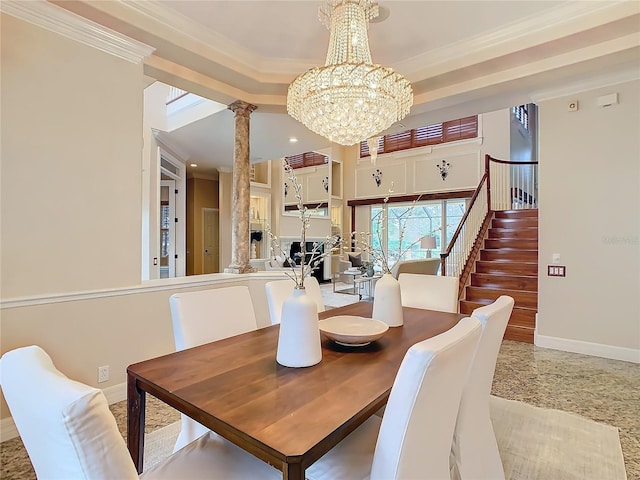 dining space featuring an inviting chandelier, crown molding, and decorative columns