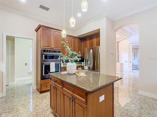 kitchen featuring decorative light fixtures, double wall oven, a kitchen island, stainless steel fridge, and stone countertops