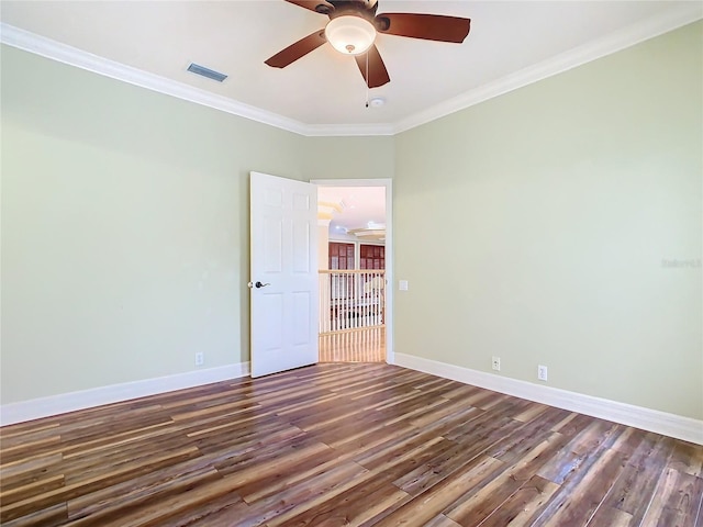 spare room featuring ceiling fan, dark wood-type flooring, and ornamental molding