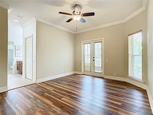 empty room featuring ceiling fan, dark hardwood / wood-style flooring, ornamental molding, and french doors