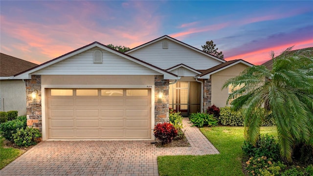 view of front of house featuring a garage and a yard