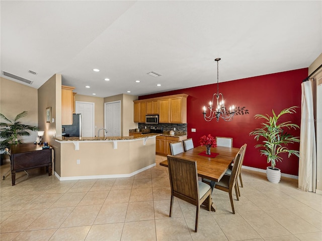 dining room with light tile patterned flooring and an inviting chandelier