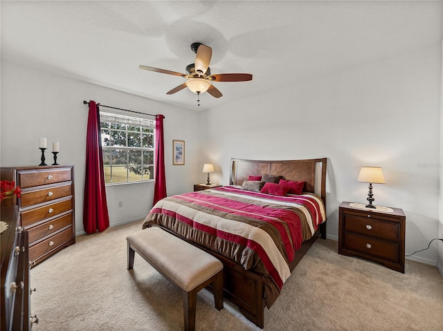 bedroom featuring ceiling fan and light colored carpet