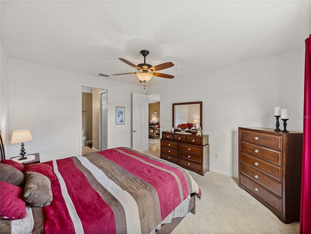 carpeted bedroom with ceiling fan and connected bathroom