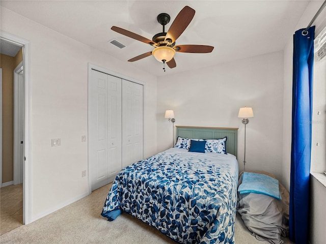 carpeted bedroom with ceiling fan and a closet