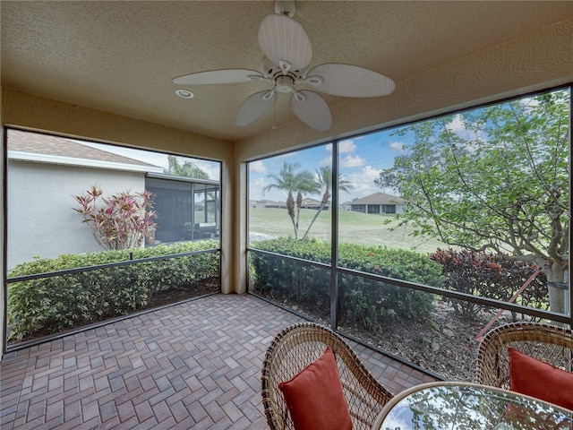 sunroom / solarium with ceiling fan