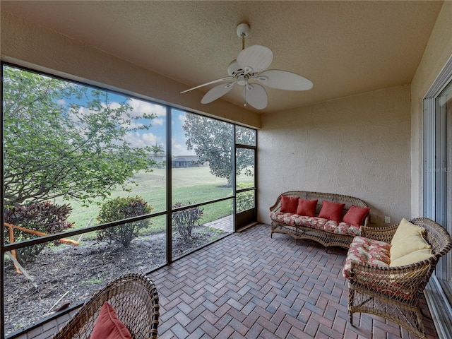 sunroom featuring ceiling fan