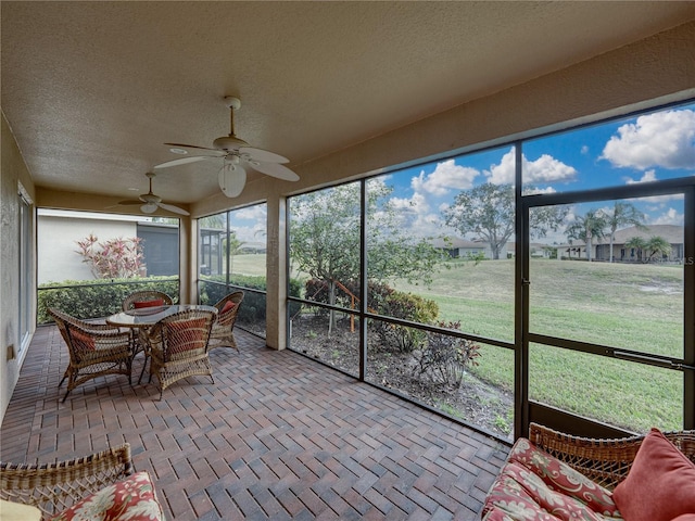 sunroom featuring ceiling fan