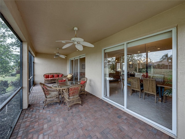 sunroom / solarium with ceiling fan and a healthy amount of sunlight