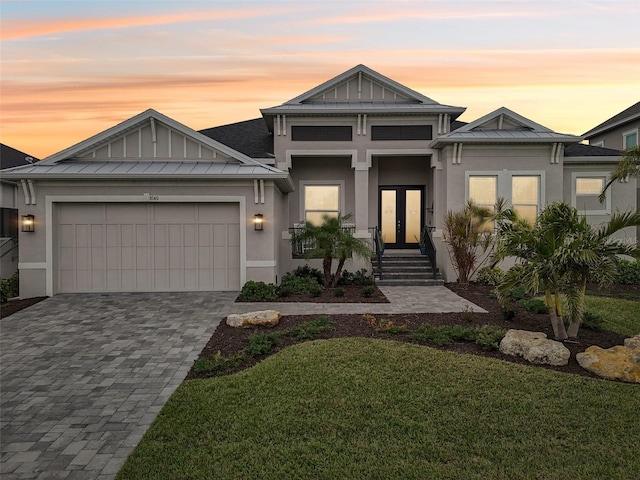 view of front of house with a garage and a yard