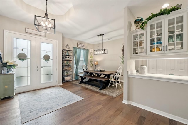 foyer with dark wood-type flooring, plenty of natural light, and french doors