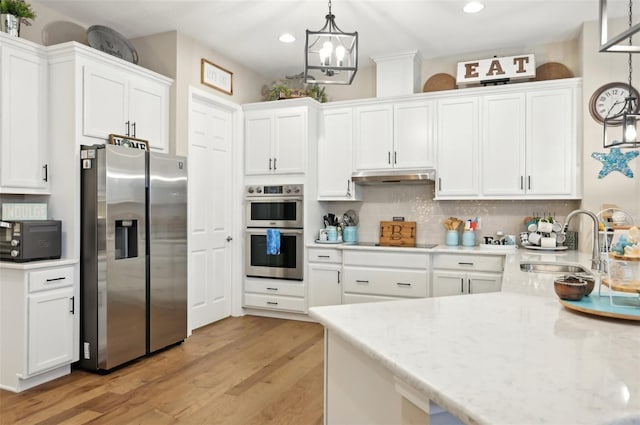 kitchen with white cabinetry, stainless steel appliances, decorative backsplash, decorative light fixtures, and sink