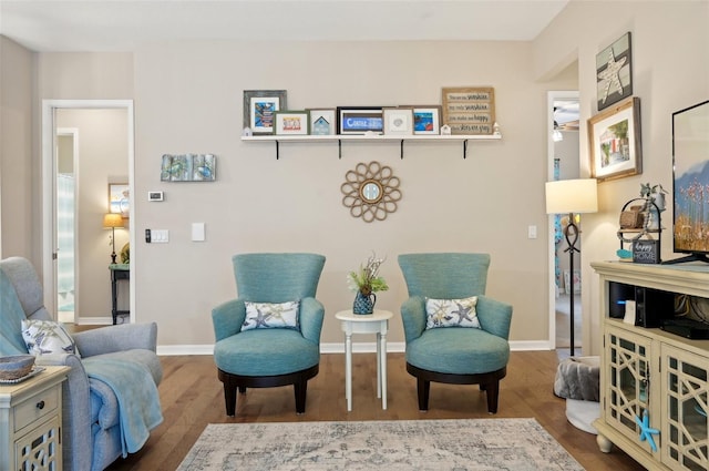 living area with hardwood / wood-style flooring