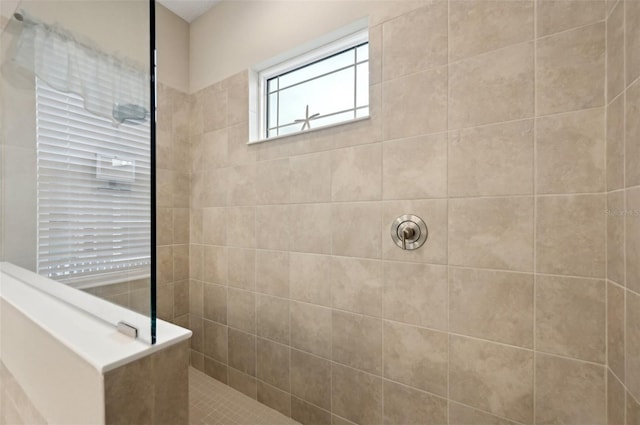 bathroom with a tile shower