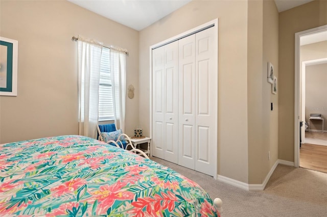 bedroom featuring light carpet and a closet