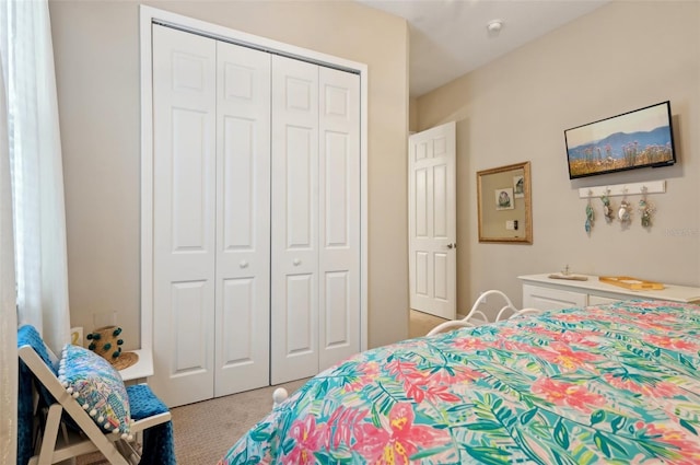 bedroom with light colored carpet and a closet