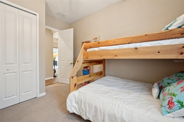 carpeted bedroom with a closet