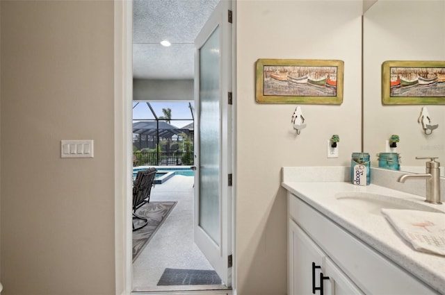 bathroom featuring a textured ceiling and vanity