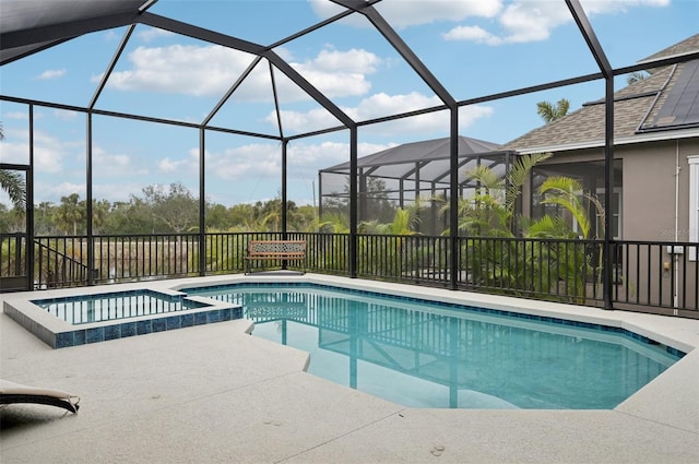 view of swimming pool with a patio, glass enclosure, and an in ground hot tub