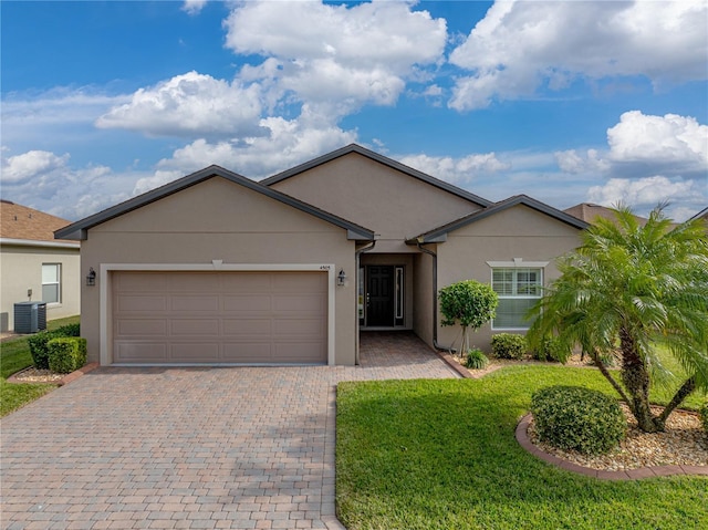 ranch-style home featuring a garage, central AC, and a front yard