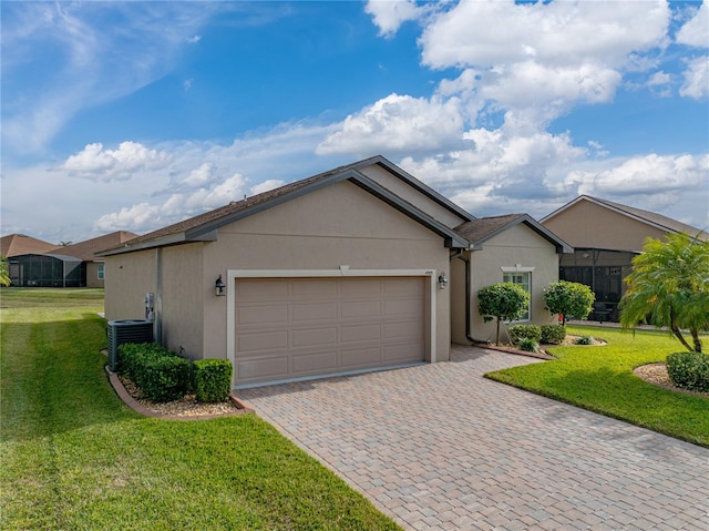 ranch-style house featuring a garage, central AC, and a front lawn