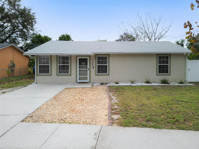 ranch-style home featuring a front yard