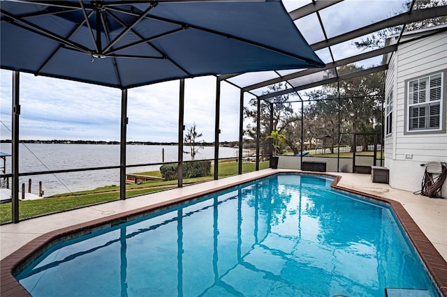 view of pool with glass enclosure, a water view, and a patio