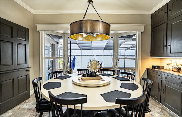 dining space with crown molding and a water view