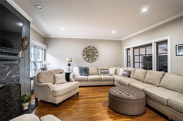 living room with a fireplace, dark hardwood / wood-style floors, and ornamental molding