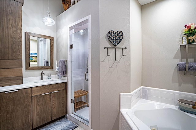 bathroom with separate shower and tub and vanity