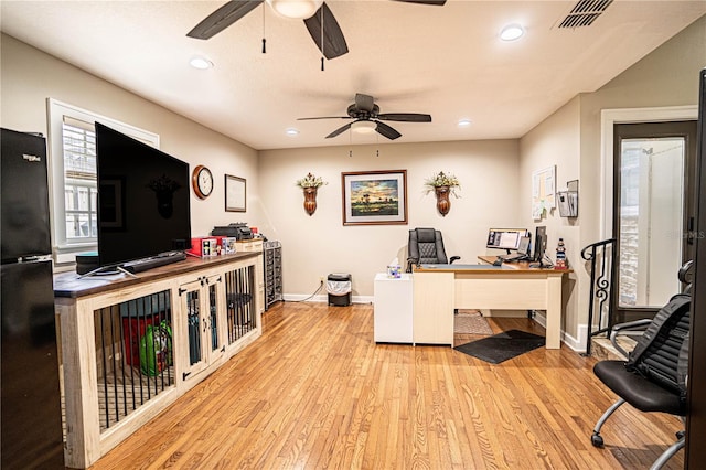 office with ceiling fan and light hardwood / wood-style flooring