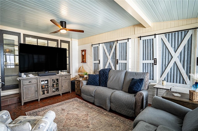 living room with ceiling fan and beamed ceiling