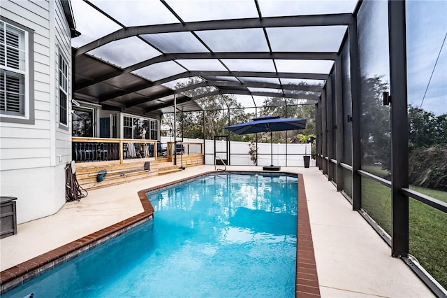 view of pool with a patio area and a lanai