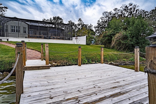 wooden deck with glass enclosure and a lawn