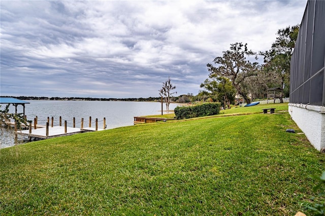 view of yard with a boat dock and a water view