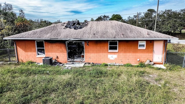 rear view of house with central AC unit