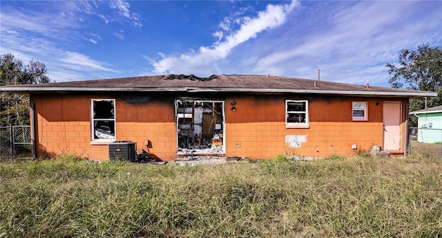 back of house featuring central air condition unit