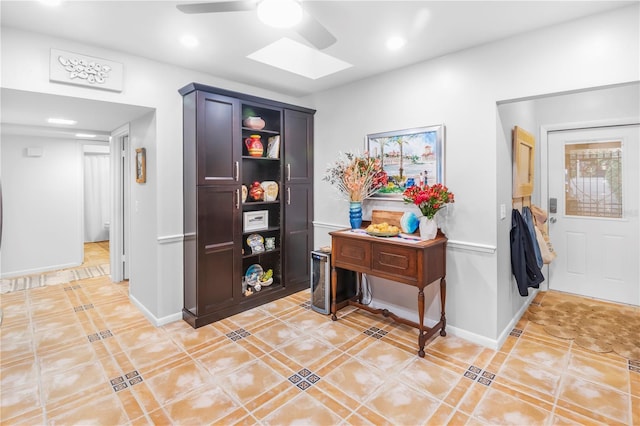 interior space with ceiling fan and a skylight