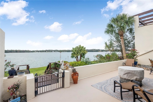 view of patio with a water view