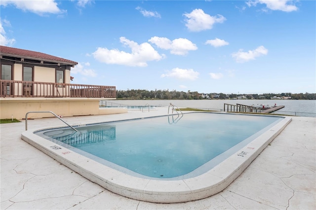 view of swimming pool with a water view