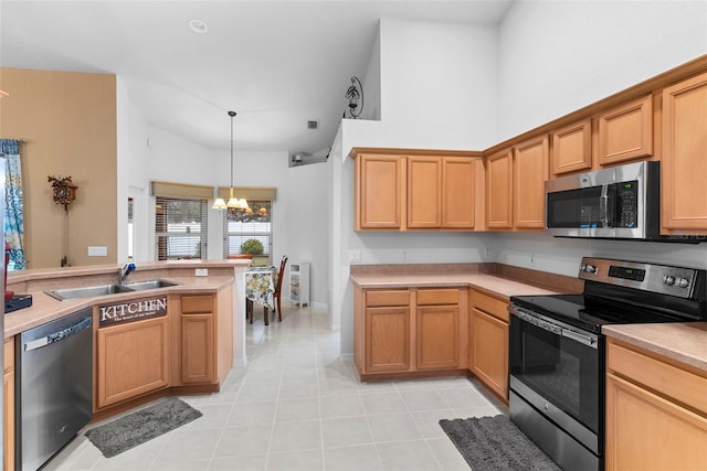 kitchen featuring light tile patterned floors, appliances with stainless steel finishes, decorative light fixtures, a chandelier, and sink