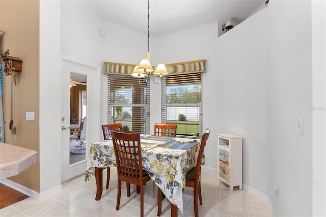 tiled dining room with a notable chandelier