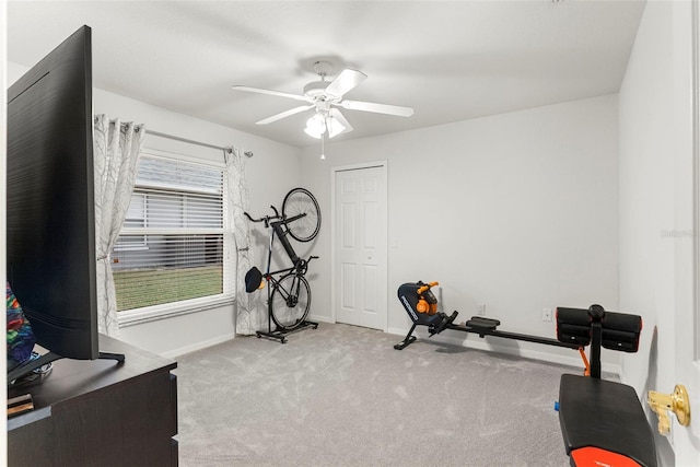 exercise room featuring ceiling fan, light colored carpet, and plenty of natural light