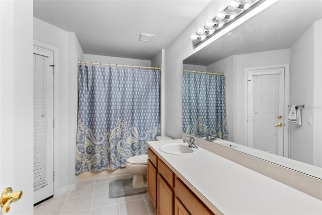 bathroom with toilet, tile patterned flooring, a textured ceiling, vanity, and curtained shower