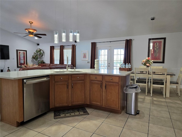 kitchen with pendant lighting, dishwasher, and a center island with sink