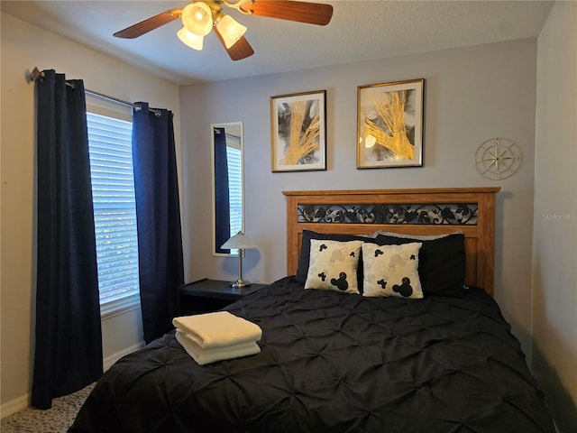 carpeted bedroom with ceiling fan and multiple windows